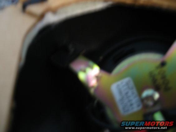 Car speaker with yellow and green metal bracket and white label