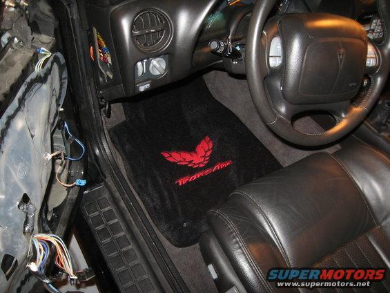 Black leather seats and floor mats with red Trans Am bird logo inside a 2002 Pontiac Trans Am