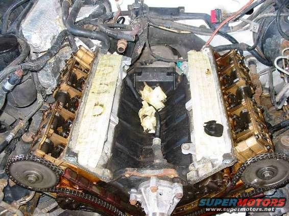Engine with valve covers removed, showing timing chains and internal components