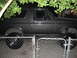 1993 Ford Bronco - This lifted 1993 Ford Bronco features a dark gray exterior and is parked behind a chain-link fence.