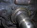 1995 Ford F-250 - Close-up of a greasy differential axle seal and shaft, likely needing replacement.