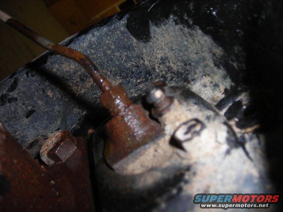 Rusty brake line connection on underside of vehicle