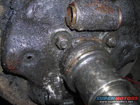 Greasy axle housing and spindle with visible bolts and bearings