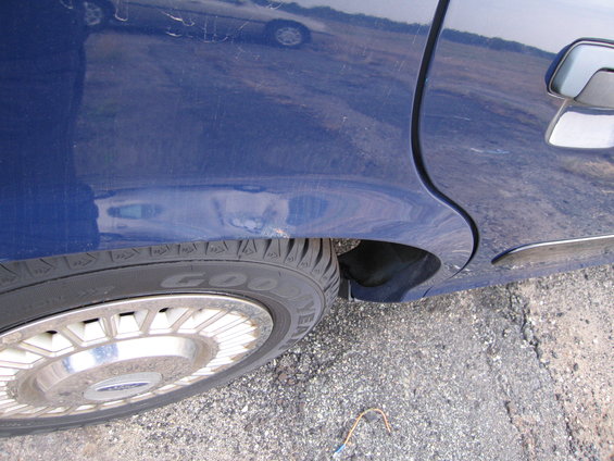 Blue 1991 Ford Crown Victoria LTD sedan, rear quarter panel and wheel, side view