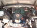 1978 Ford Bronco - The engine bay of a vehicle is exposed, revealing the engine and various mechanical parts.
