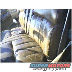 Brown leather bench seat with visible wear and seatbelts