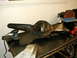 1996 Ford Bronco - A rear differential housing sits on a workbench, surrounded by tools including a sander and a rotary tool, suggesting maintenance or restor…