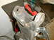 1996 Ford Bronco - Close-up of a vehicle suspension part with power tools in the background.