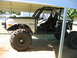 1992 Ford Mustang - This custom off-road vehicle, identified as a Bronco, features a prominent roll cage and oversized tires, suggesting significant modificati…