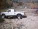 1990 Ford Ranger - Lifted 1990 Ford Ranger parked on a rocky incline with autumn foliage in the background.