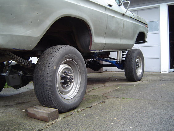 1978 Ford Bronco side view, lifted with custom blue suspension components