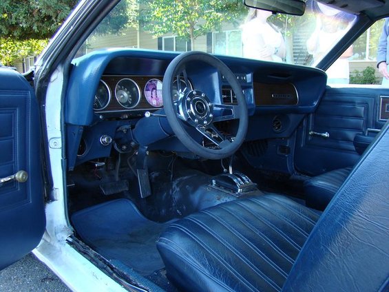 1970 Mercury Cougar interior with blue seats, dashboard, and steering wheel