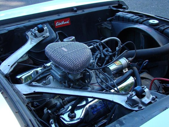 Engine bay with Edelbrock air cleaner and chrome valve covers. Visible text: Edelbrock