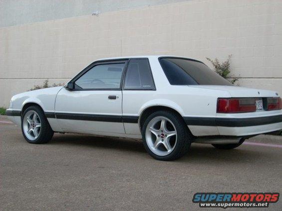 White 1991 Ford Mustang coupe, rear three-quarter view, aftermarket wheels