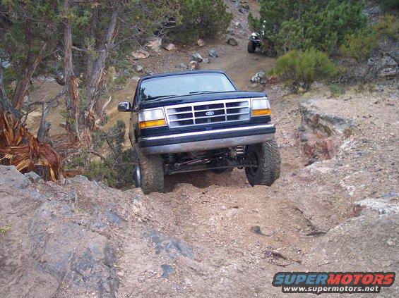 Dark blue 1995 Ford Bronco navigating rocky terrain
