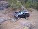 1995 Ford Bronco - This 1995 Ford Bronco is tackling a challenging off-road trail with steep inclines and large rocks.