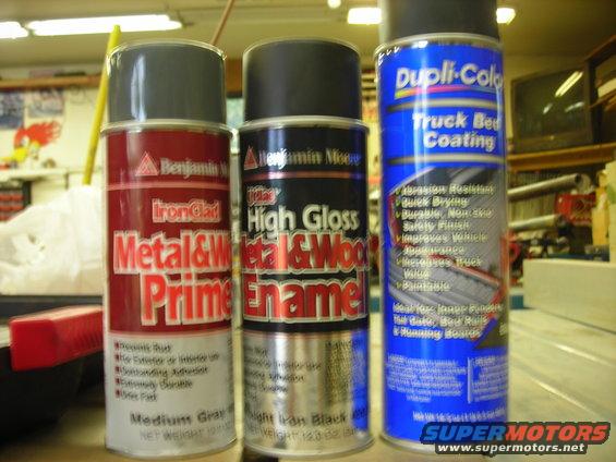 Three cans of spray paint: Benjamin Moore IronClad Metal & Wood Primer, Benjamin Moore High Gloss Metal & Wood Enamel, and Dupli-Color Truck Bed Coating