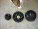 1995 Ford F-250 - Three automotive brake parts are laid out on a concrete surface.