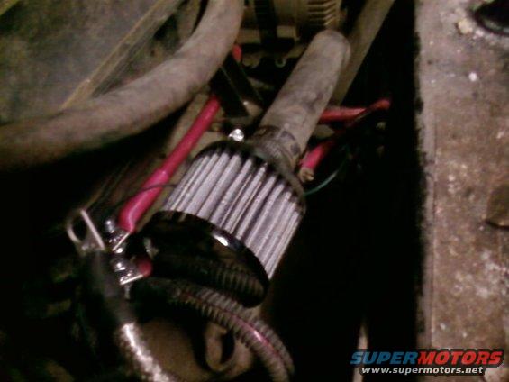 Engine bay with aftermarket air filter and red wiring