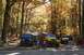 1992 Jeep Cherokee - A group of Jeep Wranglers are parked on a dirt road surrounded by trees with fall foliage.