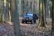1992 Jeep Cherokee - A person stands by the open door of a Jeep Wrangler in a forest during autumn.