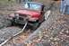 1992 Jeep Cherokee - A red Jeep Wrangler is stuck in a muddy ditch during an off-road excursion.