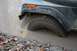 1992 Jeep Cherokee - This vehicle is stuck in a muddy puddle, with the tire submerged.