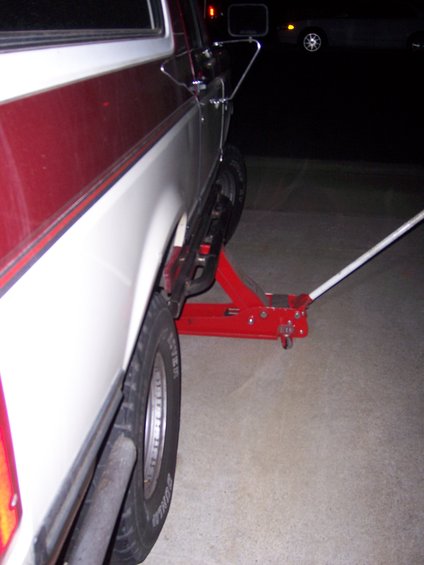 Side view of 1991 Ford Bronco with sliders being jacked up