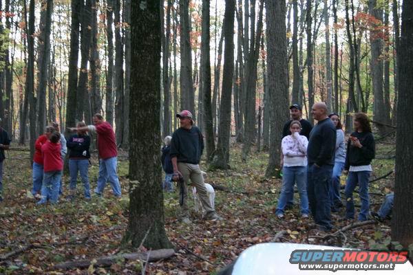 Group of people standing in a forest during autumn