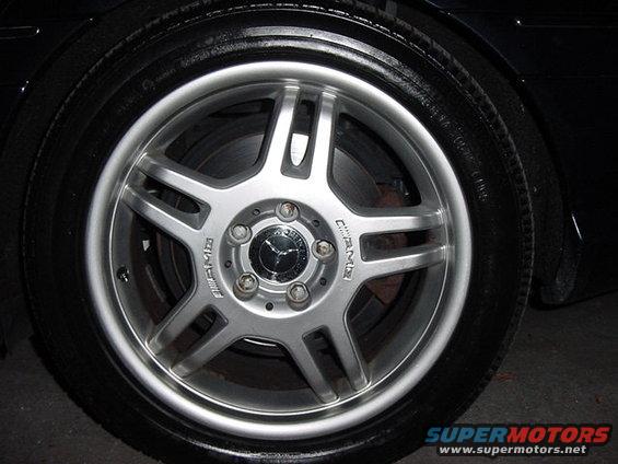 Close-up of a silver Mercedes-Benz AMG wheel with the Mercedes-Benz logo in the center