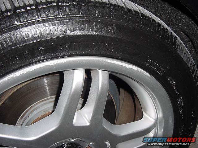 Close-up of a car wheel with tire showing "Continental" and size information