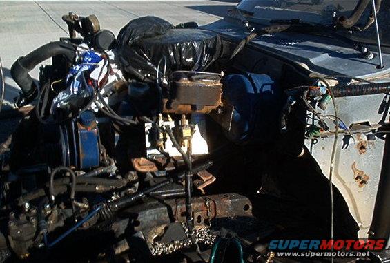 Engine bay with various parts and wiring