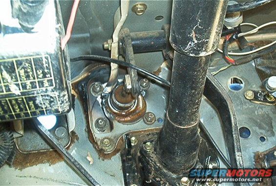 Clutch master cylinder assembly with rusty components and wiring, viewed from above