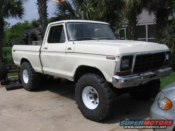 White 1979 Ford F-150 pickup truck with large tires, parked outdoors