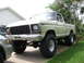 1979 Ford F-150 - This lifted 1979 Ford F-150 pickup truck features prominent off-road tires and a classic grille design.