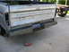 1979 Ford F-150 - The rear of a Ford pickup truck, showing the tailgate and bumper. A spare tire carrier is visible on the right.