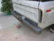 1979 Ford F-150 - Rear view of a silver 1979 Ford F-150 pickup truck with a diamond plate bumper and a missing taillight.