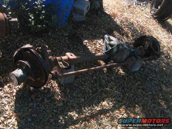 Dana 60 axle assembly with disc brakes, resting on blocks outdoors