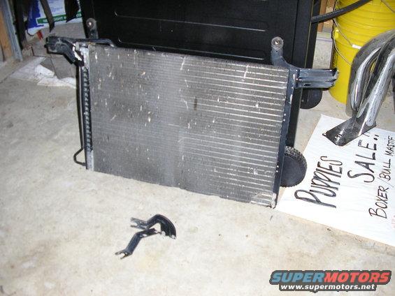 Radiator with mounting brackets and a sign for puppy sale