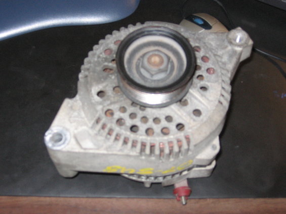 Metal alternator with yellow markings, showing pulley and mounting points