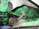 1979 Ford F-150 - Close-up view of the engine and exhaust system, showing green painted components and a white exhaust pipe.