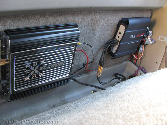 Two car audio amplifiers mounted in a vehicle's interior