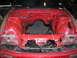 1992 Nissan 240SX - The engine bay of a red car is shown, stripped down and ready for work. A sticker reads HA-Toro.