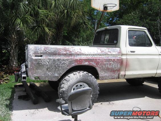 Side view of 1979 Ford F-150 with bed stripped for body work