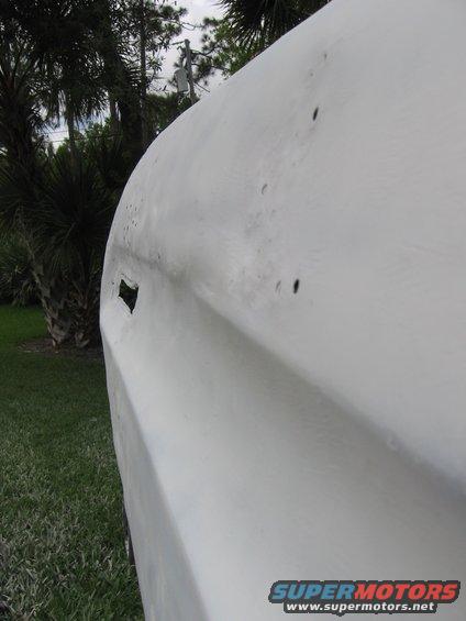 1979 Ford F-150 door panel with primer, showing body lines and a rectangular cutout