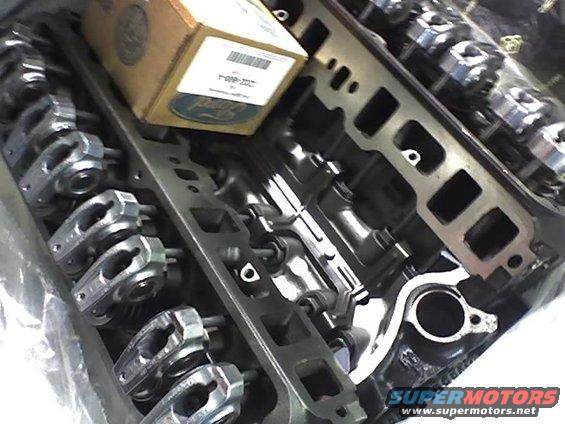 Engine intake manifold and rocker arms with a Ford branded box