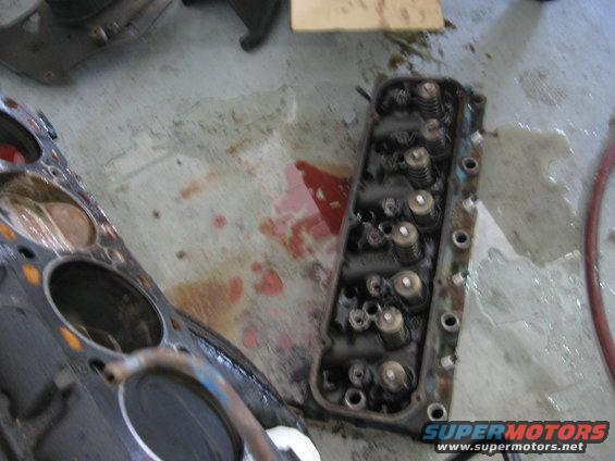 Engine block and cylinder head on concrete floor