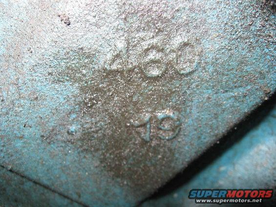 Close-up of a blue engine block casting with raised numbers '460' and '79'