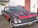 1962 Ford Galaxie - This customized sedan features a striking flame paint job on the hood and sides, with a prominent chrome grille and dual headlights.
