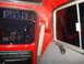 1979 Ford F-150 - The interior of a 1979 Ford F-150 cab, red paneling, a seat, and shelves stocked with various bottles.